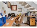 Cozy office space with built-in desk, shelves, and comfortable chair under the stairs at 6303 23Rd N St, St Petersburg, FL 33702