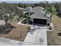 This single-story home is complete with a spacious driveway and perfectly manicured landscape with many trees at 920 Regal Manor Way, Sun City Center, FL 33573