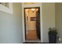 View of the inviting entryway, tiled floors, and a glimpse of the chandelier through the arched doorway at 920 Regal Manor Way, Sun City Center, FL 33573