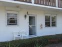 Inviting condo showcasing a well-lit entryway, white exterior, and neat landscaping at 1 Quails Run Blvd # 2, Englewood, FL 34223
