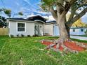 Lovely single-Gathering home with lush green grass and a mature tree in the front yard at 10118 66Th Ave, Seminole, FL 33772