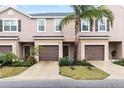 Inviting exterior view of townhomes, showcasing dark shutters and a lush, landscaped lawn at 1034 Grantham Dr, Sarasota, FL 34234