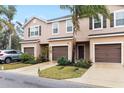 Inviting exterior view of townhomes, showcasing dark shutters and a lush, landscaped lawn on a cloudy day at 1034 Grantham Dr, Sarasota, FL 34234