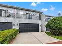Inviting townhome featuring a private balcony, two-car garage and a meticulously maintained landscape at 1118 S Moody Ave, Tampa, FL 33629