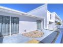 Private patio area with sliding glass doors and a low-maintenance rock garden at 1655 S Highland Ave # B110, Clearwater, FL 33756