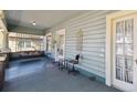 Comfortable front porch with wood flooring, swing and lots of space for sitting and enjoying the outdoors at 306 S Albany Ave, Tampa, FL 33606