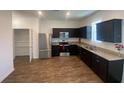 Modern kitchen featuring stainless steel appliances and granite countertops at 35220 White Water Lily Way, Zephyrhills, FL 33541