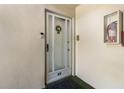 Welcoming condo front door featuring a storm door, unit number, and a decorative wreath for added curb appeal at 3824 37Th S St # 65, St Petersburg, FL 33711