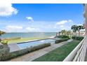 Incredible waterfront pool with pristine bay views and lush landscaping for relaxation at 4951 Bacopa S Ln # 103, St Petersburg, FL 33715