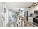 Open concept kitchen with dining area, stainless steel appliances, and a view to the living room at 5915 Sea Ranch Dr # 703, Hudson, FL 34667