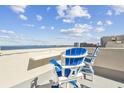 Rooftop deck featuring white Adirondack chairs with blue trim overlooking a gorgeous ocean view at 5915 Sea Ranch Dr # 703, Hudson, FL 34667