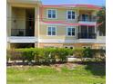 A bright and sunny image of the exterior featuring the balcony and multiple windows at 6421 Banyan Blvd # 302, New Port Richey, FL 34652