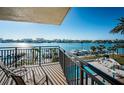 Balcony view overlooking calm waters, with lounge chairs, boats, and clear blue skies at 690 Island Way # 404, Clearwater Beach, FL 33767