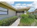 A welcoming entrance with a well-manicured green lawn and beautiful landscaping at 7245 Wood Creek Dr # 29, Sarasota, FL 34231