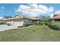 The well-manicured lawn and tidy landscaping enhance the curb appeal of this beige one-story home at 7245 Wood Creek Dr # 29, Sarasota, FL 34231