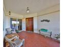 Inviting covered balcony entrance with ample seating and tiled flooring, perfect for relaxation and greeting guests at 1030 Bellasol Way # 302, Apollo Beach, FL 33572