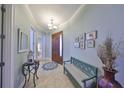 Welcoming foyer features a charming bench, console table, and decorative accents, leading into the home at 1030 Bellasol Way # 302, Apollo Beach, FL 33572