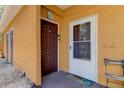 A condo entrance with a brown door and a storm door at 10764 70Th Ave # 2110, Seminole, FL 33772