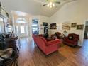 Inviting living room with high ceilings, wood-look tile flooring, and plenty of natural light at 11040 Flicker Rd, Brooksville, FL 34613