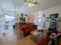 Spacious living room featuring wood-look flooring, vaulted ceiling, and an open layout at 11040 Flicker Rd, Brooksville, FL 34613