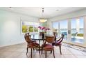 Elegant dining room with natural lighting and access to outdoor patio with waterfront view at 11385 9Th E St, Treasure Island, FL 33706
