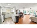 Open-concept living room seamlessly connects to the kitchen and dining area at 1801 E Mcberry St, Tampa, FL 33610