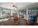 Cozy sunroom filled with natural light, wood-look tile floors, multiple windows and ceiling fan at 1904 Pepperwood Pl, Brandon, FL 33510