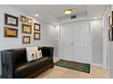 Elegant entryway with a black leather bench, unique tiger rug, and white double doors at 201 W Laurel St # 1006, Tampa, FL 33602
