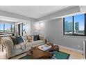 Inviting living room featuring a comfortable couch, hardwood table, and city views at 201 W Laurel St # 1006, Tampa, FL 33602