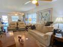 Cozy living room featuring plush seating, natural light, and comfortable furnishings at 24862 Us Highway 19 N # 3001, Clearwater, FL 33763