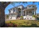 Beautiful two-story home featuring a manicured front lawn and a spacious three-car garage at 124 Leeward Is, Clearwater Beach, FL 33767