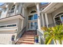 Grand front entrance with a double door, brick steps, and well-maintained landscaping at 124 Leeward Is, Clearwater Beach, FL 33767