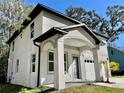 Angle view of charming two-story home featuring stucco siding and covered entryway at 16417 Lake Byrd Dr, Tampa, FL 33618