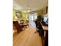 Comfortable living room featuring a ceiling fan, wood-look floors, and natural lighting at 1656 S Lake Ave # 3, Clearwater, FL 33756