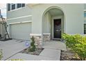 Inviting front entryway with a dark front door framed by stone accents and manicured landscaping at 16631 Mooner Plank Cir Cir, Wimauma, FL 33598