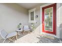 Inviting front porch with comfortable seating, a red front door, and stylish decor for a welcoming entrance at 17628 Breakaway St, Land O Lakes, FL 34638