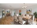 Bright dining room with hardwood floors, a chandelier, and natural light at 2032 Sunset Meadow Dr, Clearwater, FL 33763