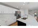 Stylish kitchen featuring white cabinets, quartz countertops, and stainless steel appliances at 2032 Sunset Meadow Dr, Clearwater, FL 33763