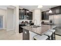 Modern kitchen featuring dark cabinets, granite countertops, and stainless steel appliances at 3568 Pine Ribbon Dr, Land O Lakes, FL 34638