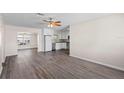 Spacious living room with modern vinyl floors and a view of the updated kitchen at 6681 32Nd N Ave, St Petersburg, FL 33710