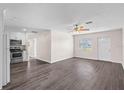 Bright living room with ceiling fan, seamlessly connected to the modern kitchen at 6681 32Nd N Ave, St Petersburg, FL 33710