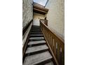 Condo outdoor staircase with stone stairs and stained wood railing leading to upper units at 722 116Th Ave N # 2002, St Petersburg, FL 33716