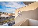 Exterior view of the building showcasing the Barbados signage and the well-kept parking area at 7465 Bay Island S Dr # 318, South Pasadena, FL 33707