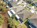 Aerial view of backyard featuring a screened patio area and lush greenery at 8208 Harwich Port Ln, Gibsonton, FL 33534