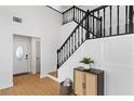 Bright foyer featuring a striking staircase with black railings and modern decor at 8814 Hampden Dr, Tampa, FL 33626