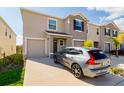 Attractive townhome showcasing a driveway, attached garage, and well-maintained front yard at 9258 Rock Harbour Way, Tampa, FL 33637