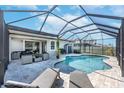 Stunning screened-in pool with lounge chairs and patio furniture, perfect for outdoor entertaining and relaxation at 10132 Tuscan Sun Ave, Riverview, FL 33578