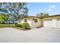 Single story home with a two-car garage and well-maintained driveway on a sunny day at 1227 Queen Anne Dr # C, Palm Harbor, FL 34684