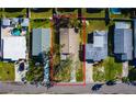 An aerial shot showcasing the roof, trees, and property boundaries of a single-story home in a neighborhood at 1826 Nevada Ne Ave, St Petersburg, FL 33703