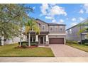 Charming two-story home showcases a well-maintained lawn, mature trees, and a convenient two-car garage at 19429 Paddock View Dr, Tampa, FL 33647